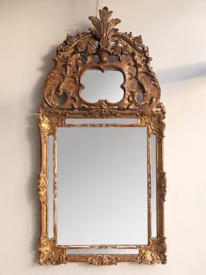 a mirror hanging on the wall above a sink