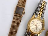 two watches sitting next to each other on a table