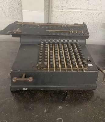 an old typewriter sitting on a table in a room