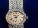 a close up of a wrist watch with roman numerals on it