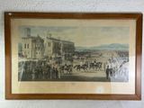 framed picture of a horse race scene with horses and jockeys