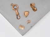 some gold pieces on a table with a key
