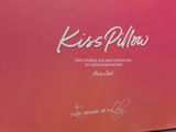 kisses pilln box with pink cover and white writing on it
