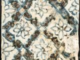 a blue and white tile with a pattern on it