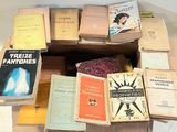 many books stacked on top of each other on a table