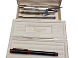 a box with a pen and two pens inside of it