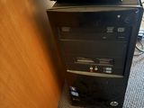 a computer tower with a keyboard on top of it