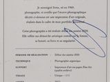 a close up of a certificate with a picture of a person holding a camera