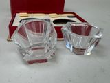 two glass ashtrays in a red box on a table