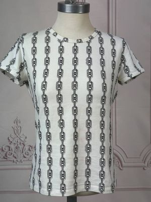 the back of a white shirt with black chains on it