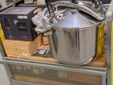 a large pot sitting on a cart in a store