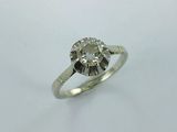 a close up of a diamond ring on a white surface