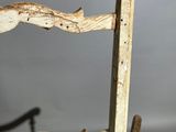 a wooden chair with a green seat and a wooden frame