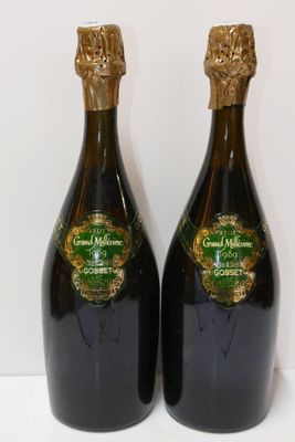 two bottles of wine sitting next to each other on a table