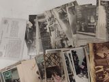 a pile of old photographs on a white table