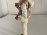 figurine of a man with a pink turban and vest