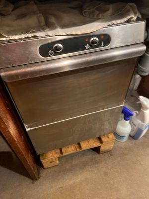 an image of a dishwasher with a bottle of water next to it