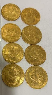 a lot of gold coins sitting on a white table