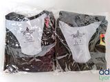 two t - shirts wrapped in plastic bags on a table