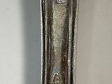 a close up of a silver spoon on a table