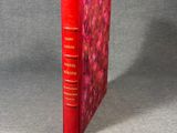 an image of a red book with a red cover on a gray surface