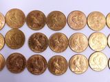 a lot of gold coins on a white surface