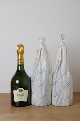 three bags of wine and a bottle of wine on a table