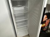 an open refrigerator in a kitchen with a lot of food inside of it