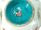 a blue bowl with a design on it on a white surface