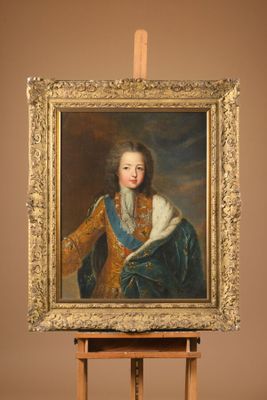 painting of a young man in a blue and gold coat holding a white cat