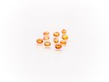a group of orange glass beads sitting on top of a white surface
