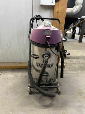 a vacuum that is sitting on the floor in the room
