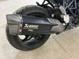 a close up of a motorcycle parked in a parking lot