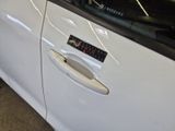 a white car with a sticker on the side of it