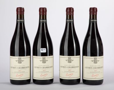 three bottles of red wine are lined up on a table