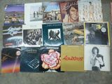 many different album covers on the floor together