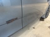 a close up of a car door with a sticker on it