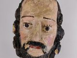 an old wooden statue of a man with a beard and mustache
