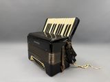 an old black accordion with a key lock on it