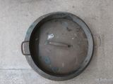 a dirty pan with a spoon in it on the floor