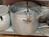several pots and pans are sitting on a shelf in a kitchen
