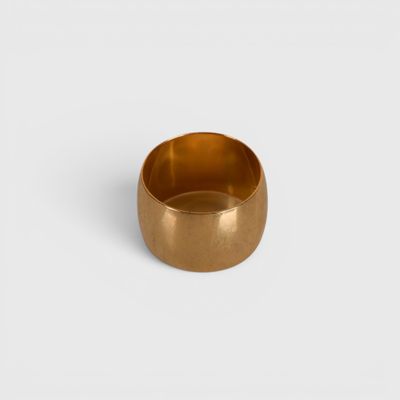 gros plan d'une bague en or sur une surface blanche