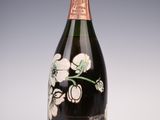 an old bottle of champagne with flowers on it