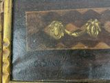 a picture of a painting of two flowers in a gold frame