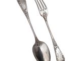 two spoons and a fork sitting next to each other