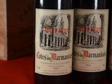 three bottles of wine sitting on top of a table next to a wooden box