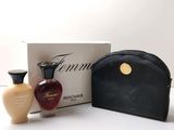 two bottles of perfume and a bag on a table