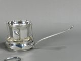 a silver cup and a pair of scissors on a table