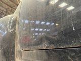 a close up of a dirty car in a garage