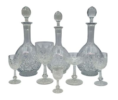 a group of wine glasses and a decanter on a table